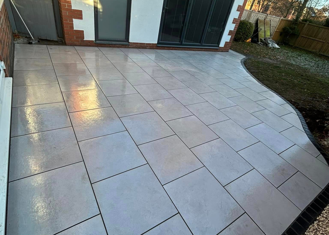 Porcelain paved patio with curved edge and charcoal edging